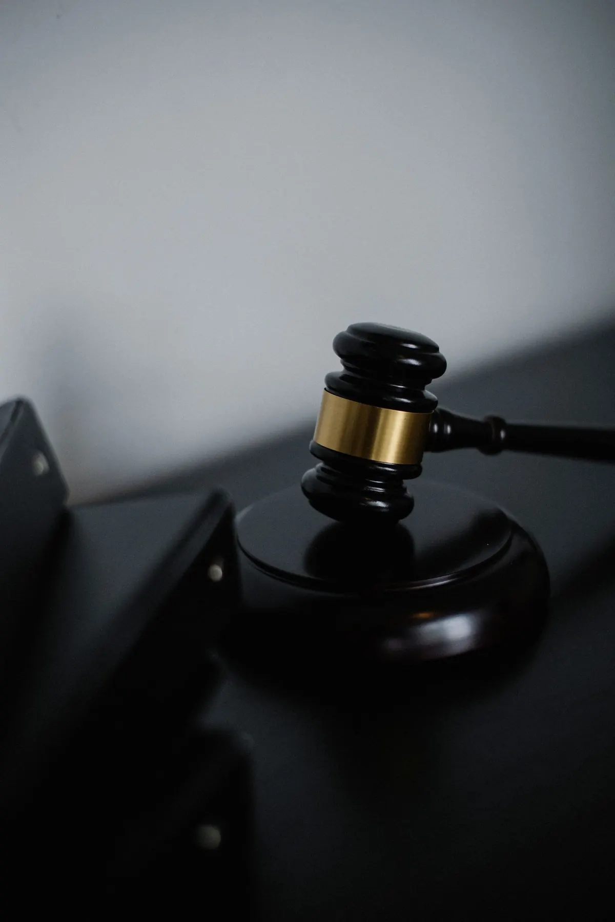 A gavel on a dark desk