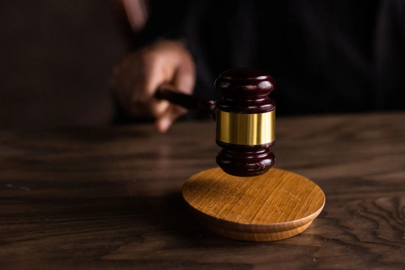 A judge's gavel on a wooden desk