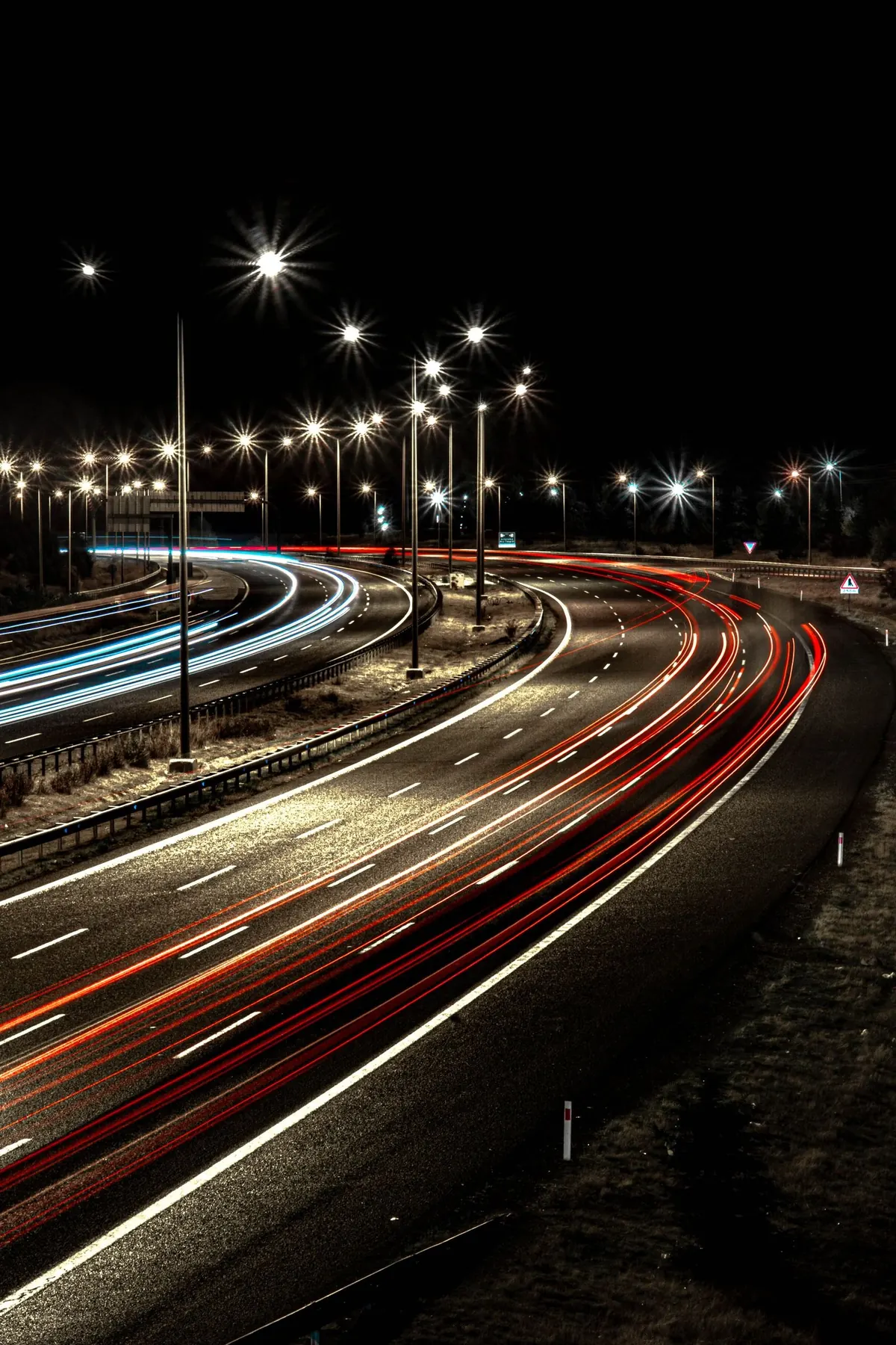 Light trails on a curving road at night